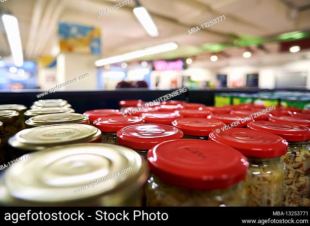 perspective view into a supermarket over canned glass on the supermarket shelf