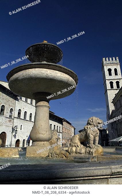 Low angle view of a fountain in front of a temple, Temple Of Minerva, Assisi, Umbria, Italy