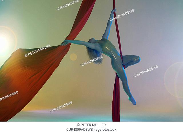 Aerial dancer with red ribbon