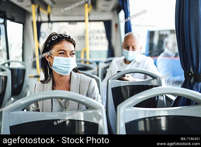 Young woman in protective mask traveling in the bus in Faro, Portugal, Europe