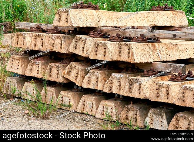 old no longer used overgrown and discarded railroad sleepers in a storage yard