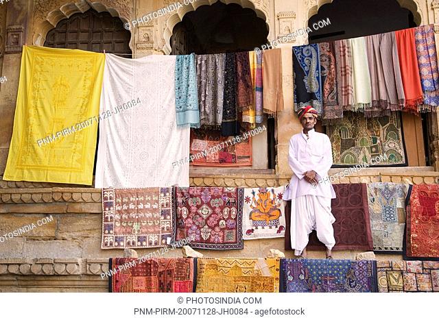 Portrait of a vendor standing in front of a building, Jaisalmer, Rajasthan, India