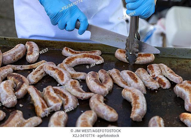 Detroit, Michigan - The annual Brazil Day Street Festival featured food and a samba dance contest. This booth grilled sausages for Brazilian Sausage Sandwiches