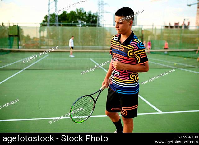 Centred male tennis player with rackets, training on outdoor court. Active healthy lifestyle, people play sport game, fitness workout with racquets