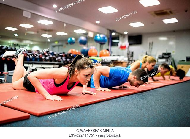 Fit people working out in fitness class