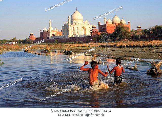 Children playing in Yamuna river at Taj Mahal Seventh Wonders of World , Agra , Uttar Pradesh , India UNESCO World Heritage Site