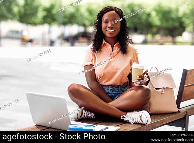 african student girl with coffee, laptop and books