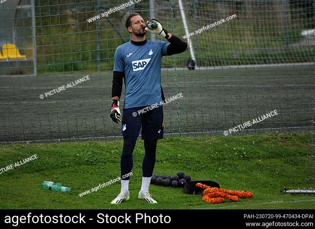 20 July 2023, Austria, Kitzbühel: Soccer, TSG 1899 Hoffenheim training camp in Kitzbühel, goalkeeper Oliver Baumann drinks from a bottle during training