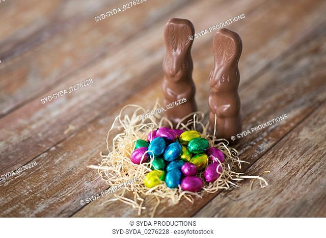 easter eggs in straw nest and chocolate bunnies
