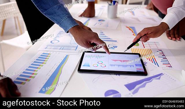 Financial Report Graph Analysis On Tablet In Business Meeting