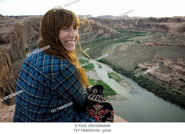 Smiling woman sitting at the Grand Canyon