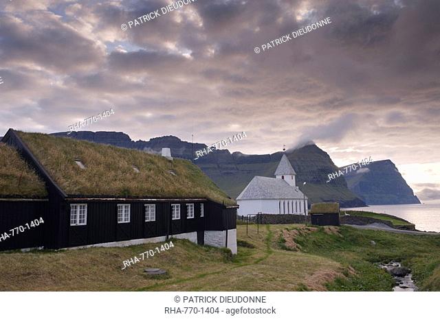 Vidareidi church dating from 1892, and turf-roofed vicarage, Vidoy Island, Nordoyar, Faroe Islands Faroes, Denmark, Europe