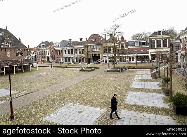man walking in city centre of Workum, Friesland, Netherlands