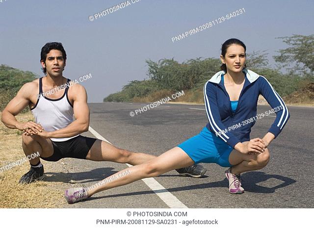 Couple exercising at the roadside