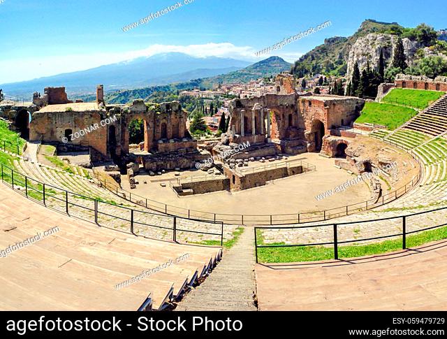The famous and beautiful ancient greek theatre ruins Taormina with Etna volcano in the distance. outdoor shot, Sicily, Italy