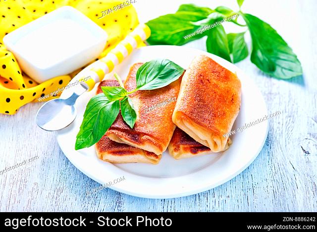 pancakes with meat and fresh basil on the plate