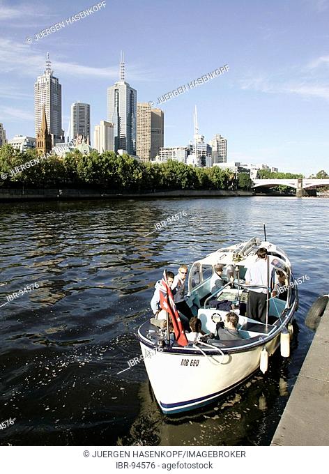 Water taxi at the southbank promenade on the Yarra River with the Princess Bridge and the city skyline in the background, Melbourne, Victoria, Australia
