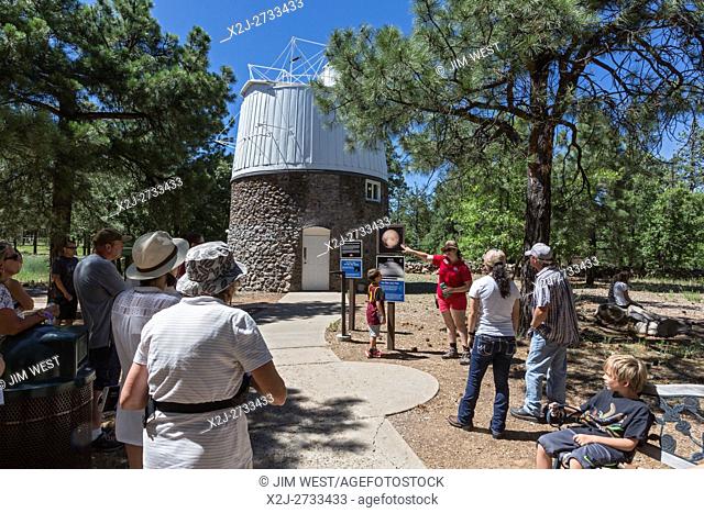 Flagstaff, Arizona - A guide tells visitors to the Lowell Observatory about the Pluto Telescope Dome. Clyde Tombaugh used the building's 13-inch astrograph...