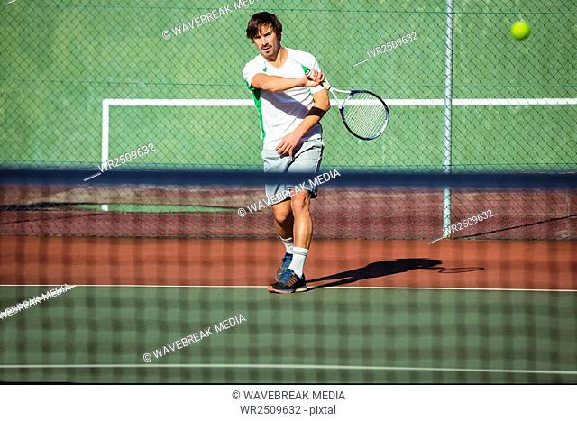 Man playing tennis in the court