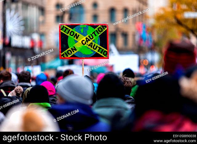 French sign seen in an ecological protest with a caution tape around the planet earth