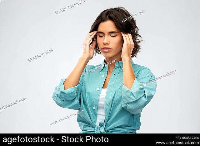 woman having headache holding to her head