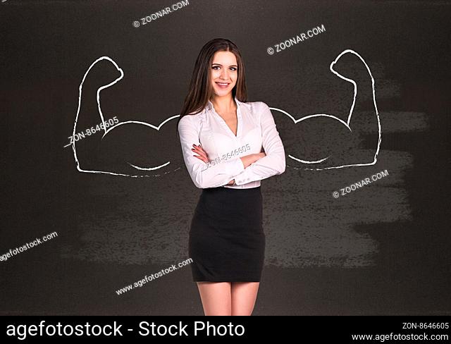 Business woman with drawn powerful hands. Black chalkboard background