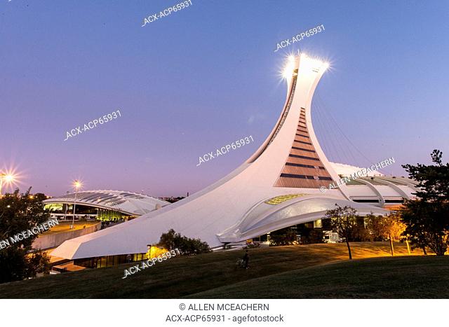The Olympic Stadium or Stade Olympique in Montreal at dusk as seen from Sherbrooke Street. The site was designed for the 1976 Summer Olympic Games by architect...