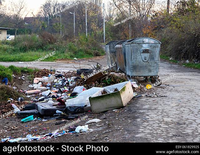 Belgrade, Serbia - November 17, 2022: Garbage pile beside dumpster scattered all over the street in Belgrade, Serbia