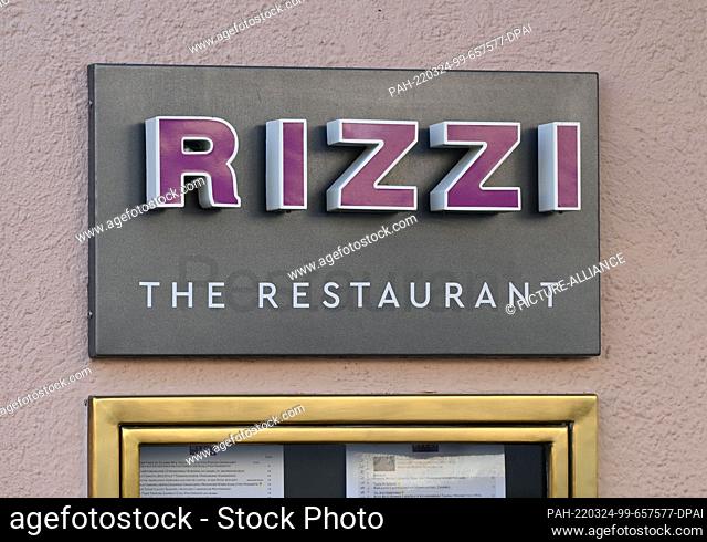 24 March 2022, Baden-Wuerttemberg, Baden-Baden: Exterior shot of the restaurant Rizzi with a sign on which the name is written