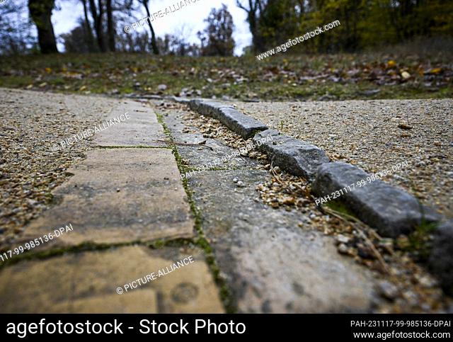 PRODUCTION - 17 November 2023, Brandenburg, Potsdam: Drainage channels can be seen on a path in Babelsberg Park. Precipitation can be directed here and used for...