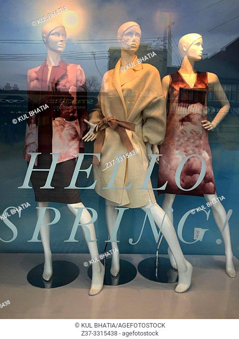 A fashionable showroom window shows the latest Spring styles, Canada