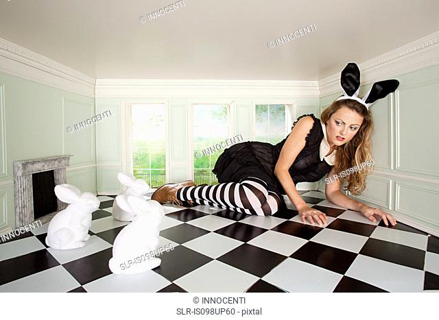 Young woman trapped with rabbits in small room