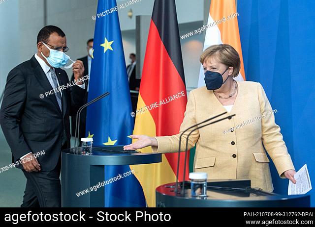 08 July 2021, Berlin: German Chancellor Angela Merkel (CDU) and Mohamed Bazoum, President of the Republic of Niger, arrive for a press conference ahead of their...