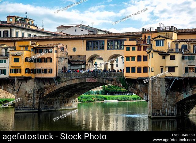 FLORENCE, TUSCANY/ITALY - OCTOBER 20 : Ponte Vecchio across the River Arno in Florence on October 20, 2019. Unidentified people