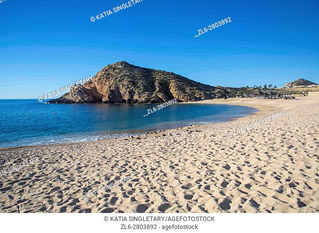 Empty beach in Cabos San Lucas, Baja California, Mexico. Ocean and mountains on a blue sky and sunny day