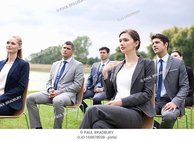 Business people having meeting outdoors looking at globe