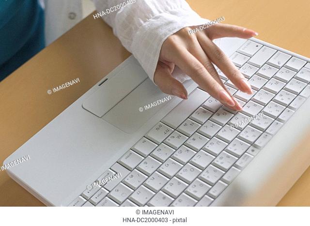 Woman's hand on laptop