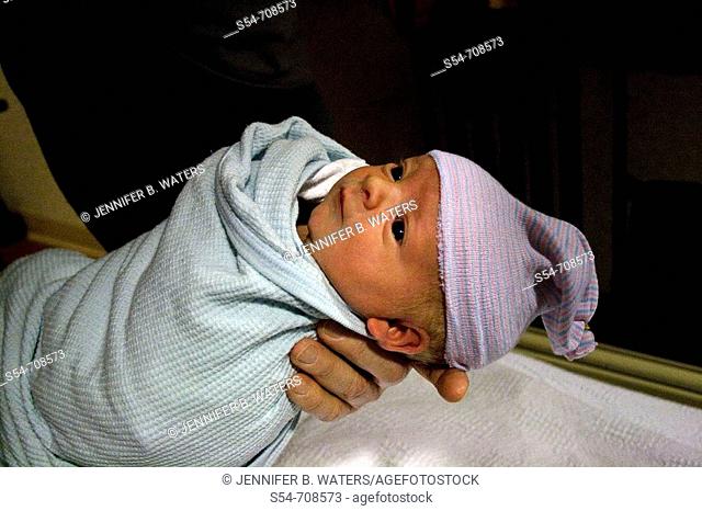 A newborn caucasian baby boy, less than one day old