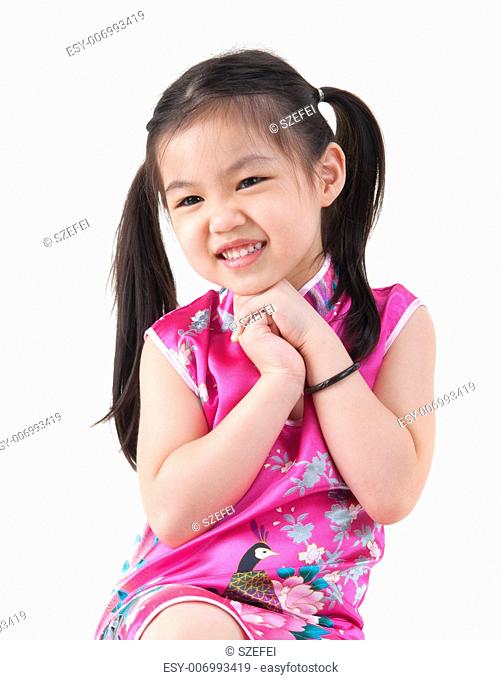 Chinese young girl in traditional Chinese cheongsam greeting, isolated on white background