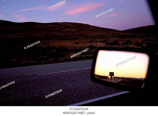 Semi In The Side View Mirror At Dusk