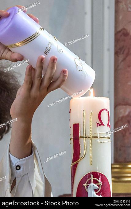 Emblematic action during the ceremony in the church - the kindling of wedding candle