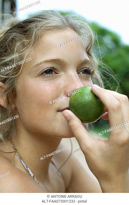 Woman smelling lime