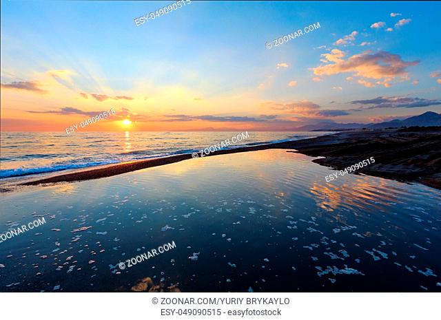 Beautiful landscape with tropical sea sunset on the beach. Picturesque sky reflection in water