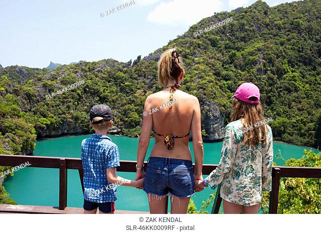 Family overlooking tropical ocean