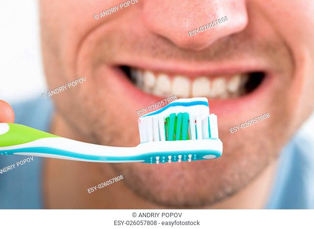 Closeup of mid adult man brushing teeth