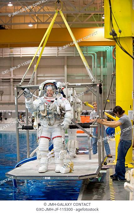 NASA astronauts Tim Kopra and Alvin Drew (partially obscured), both STS-133 mission specialists, attired in training versions of their Extravehicular Mobility...