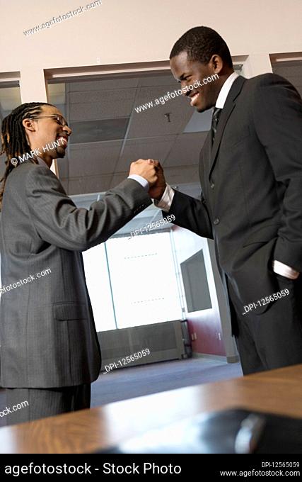 Young businessmen shaking hands