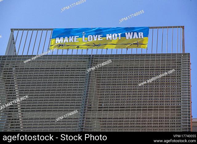 A banner reading 'Make love, not war' is mounted at the Zottegem city hall on Friday 04 March 2022, in support of the Ukrainian population after the country was...