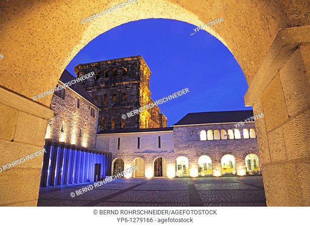 Porta Nigra with archway, illuminated at night, Trier, Germany