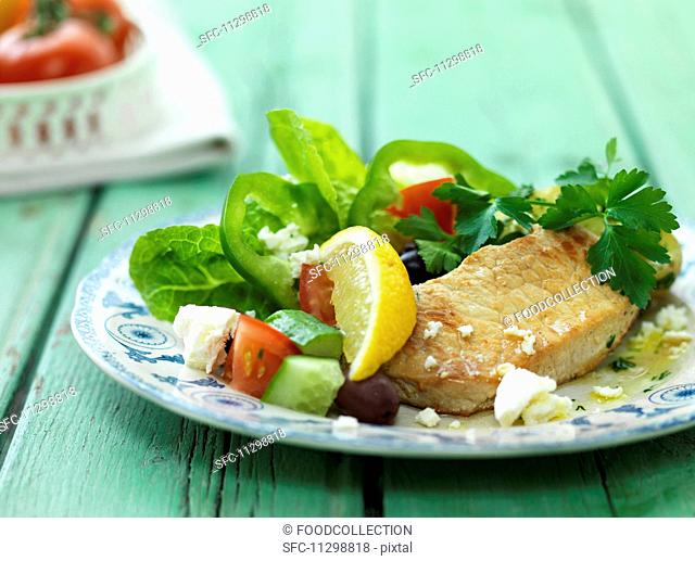 Pork escalope with a Mediterranean salad